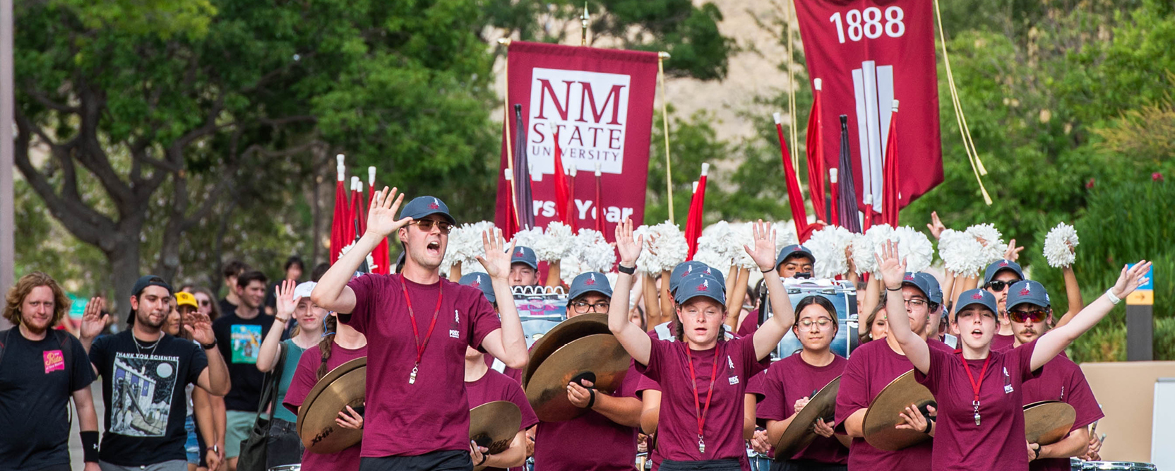Band members and freshman students walk across New Mexico State University's Las Cruces campus during the traditional First-Year Walk on Aug. 13, 2023. 