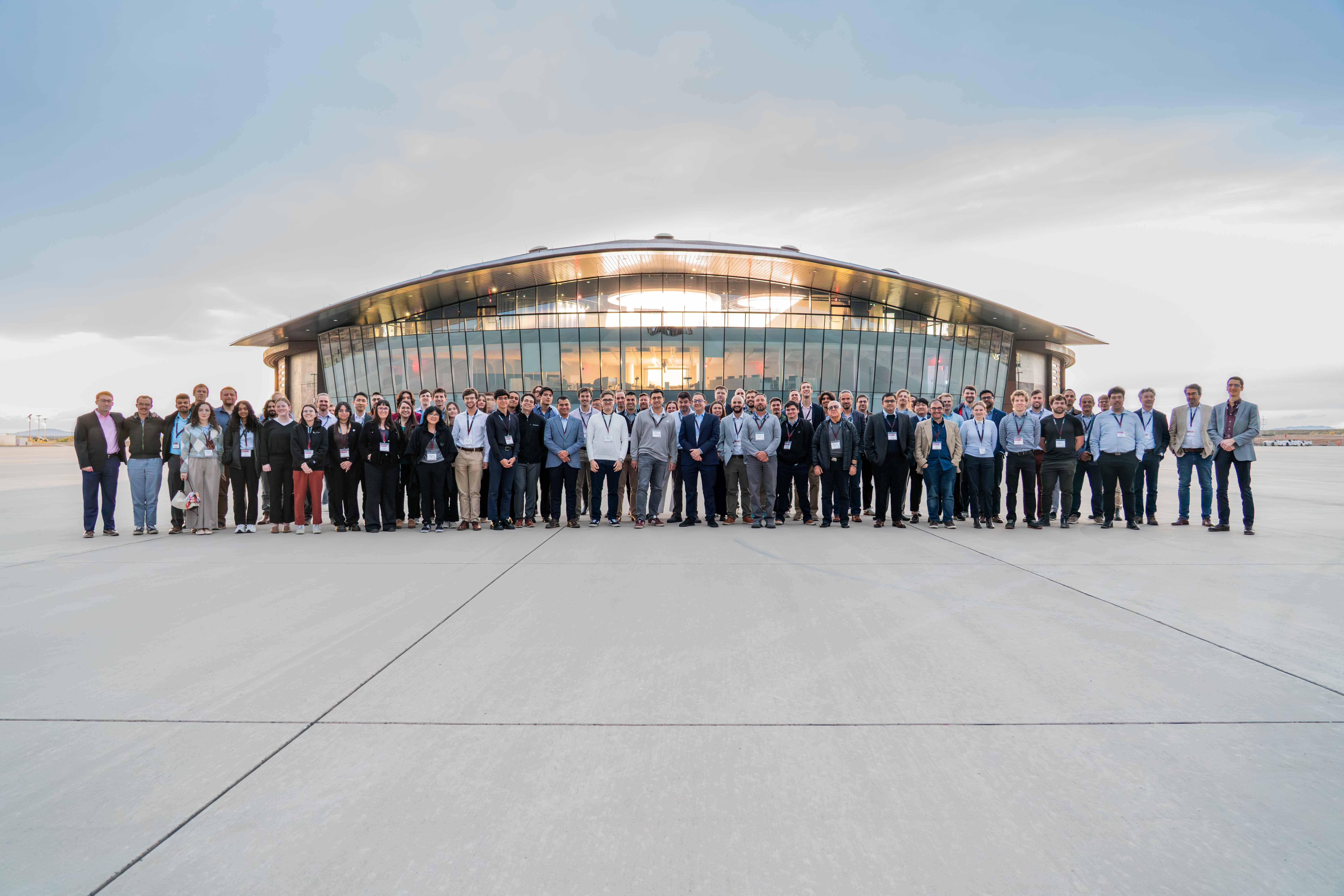 group of attendees standing in front of hanger at Spaceport America tour