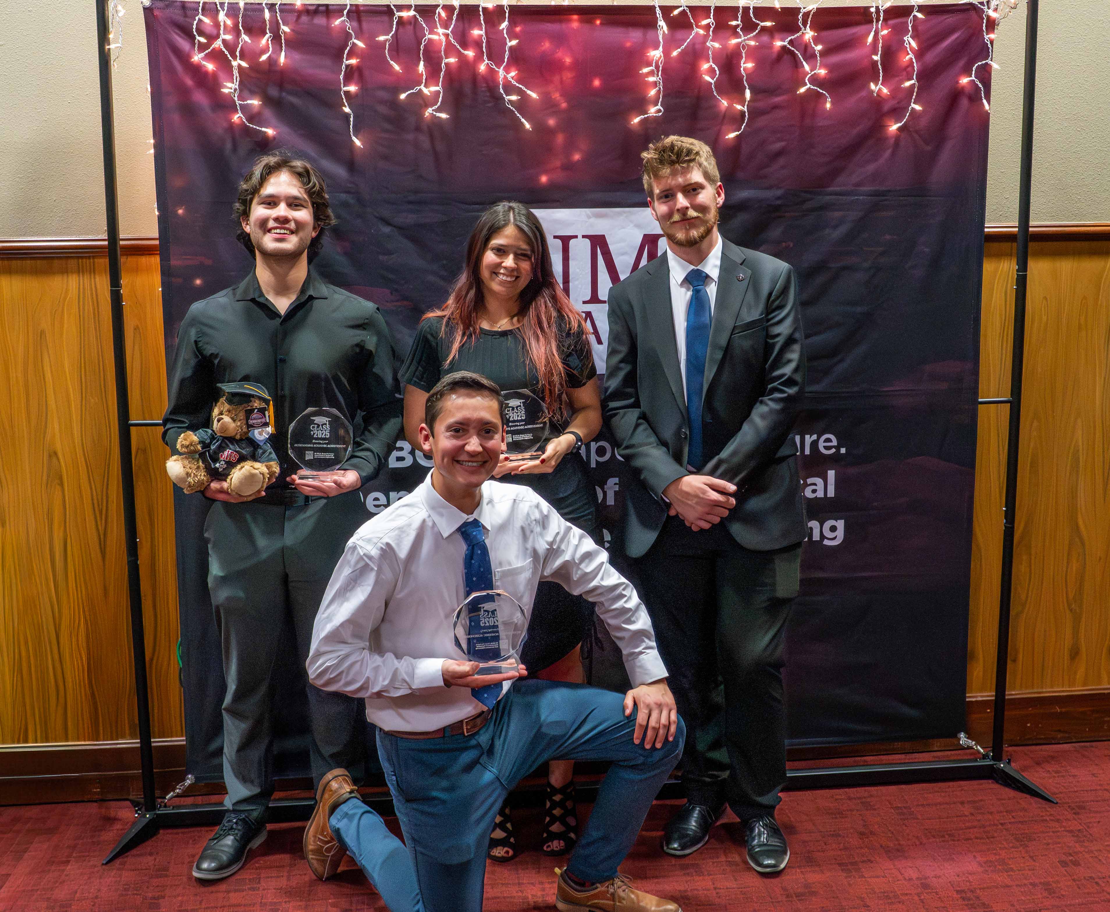 students holding crystal gifts