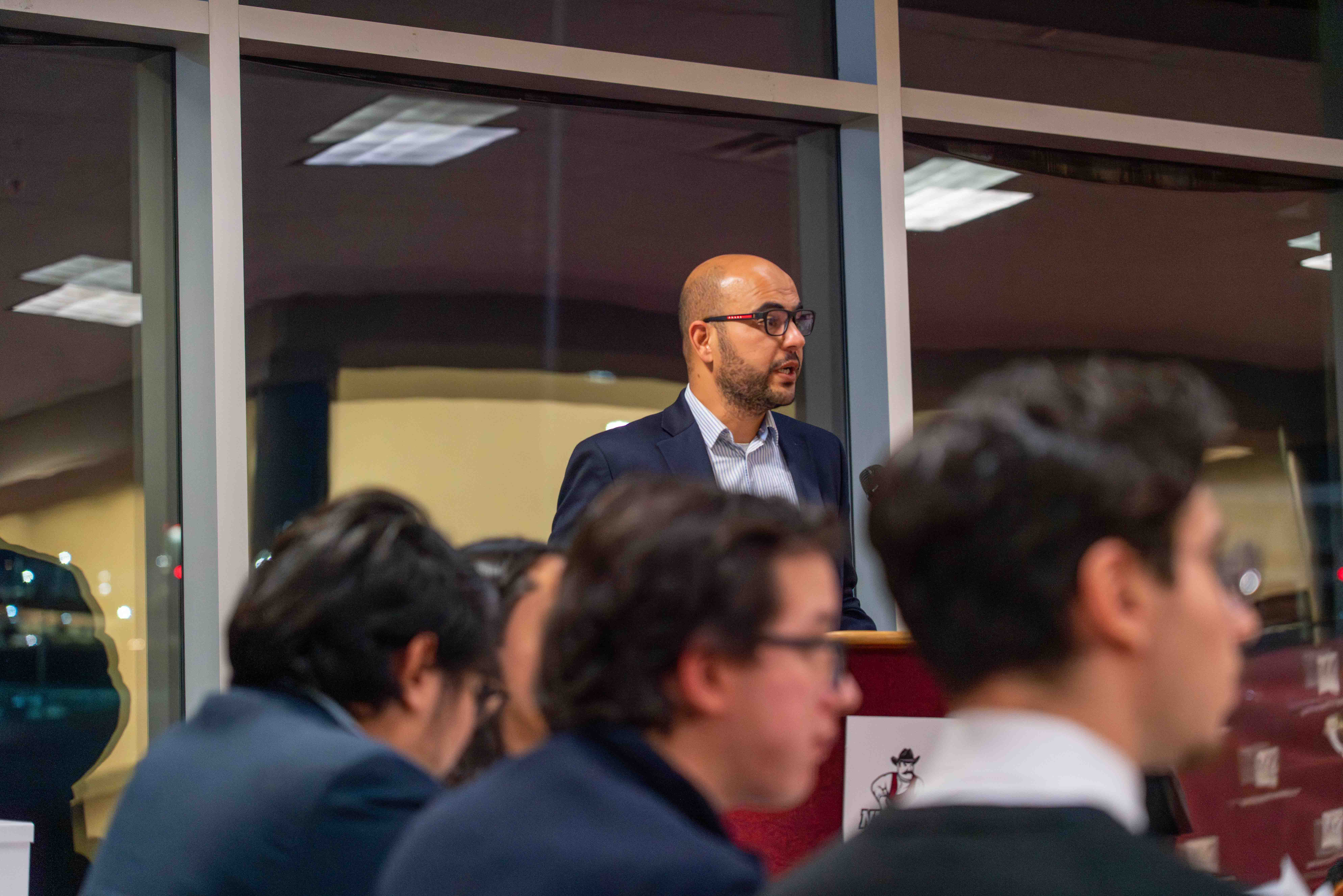 Dr. Abdelkefi speaking at podium