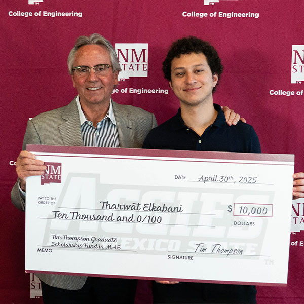 Photo of Tim Thompson and Tharwat Elkabani holding giant check