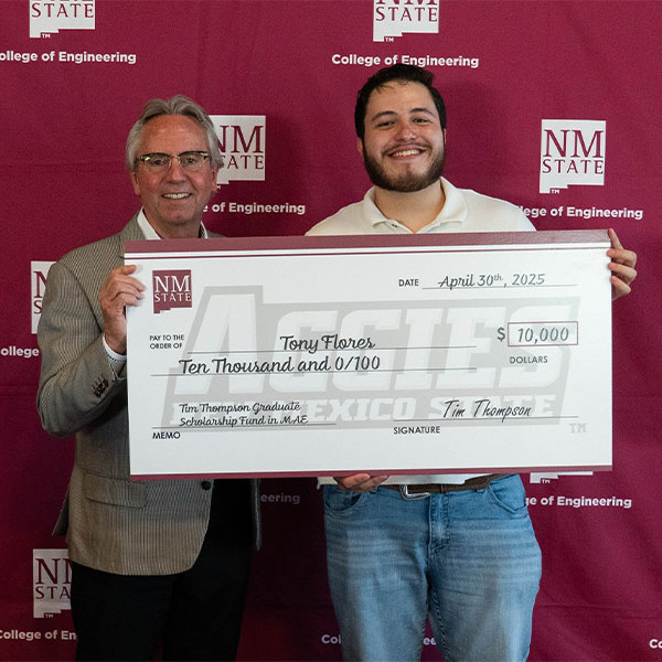 Photo of Tim Thompson and Tony Flores holding giant scholarship check