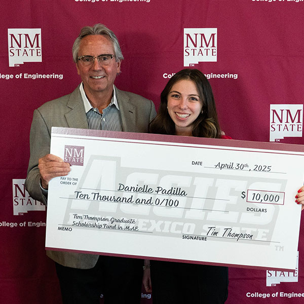 Photo of Tim Thompson and Danielle Padilla holding large scholarship check