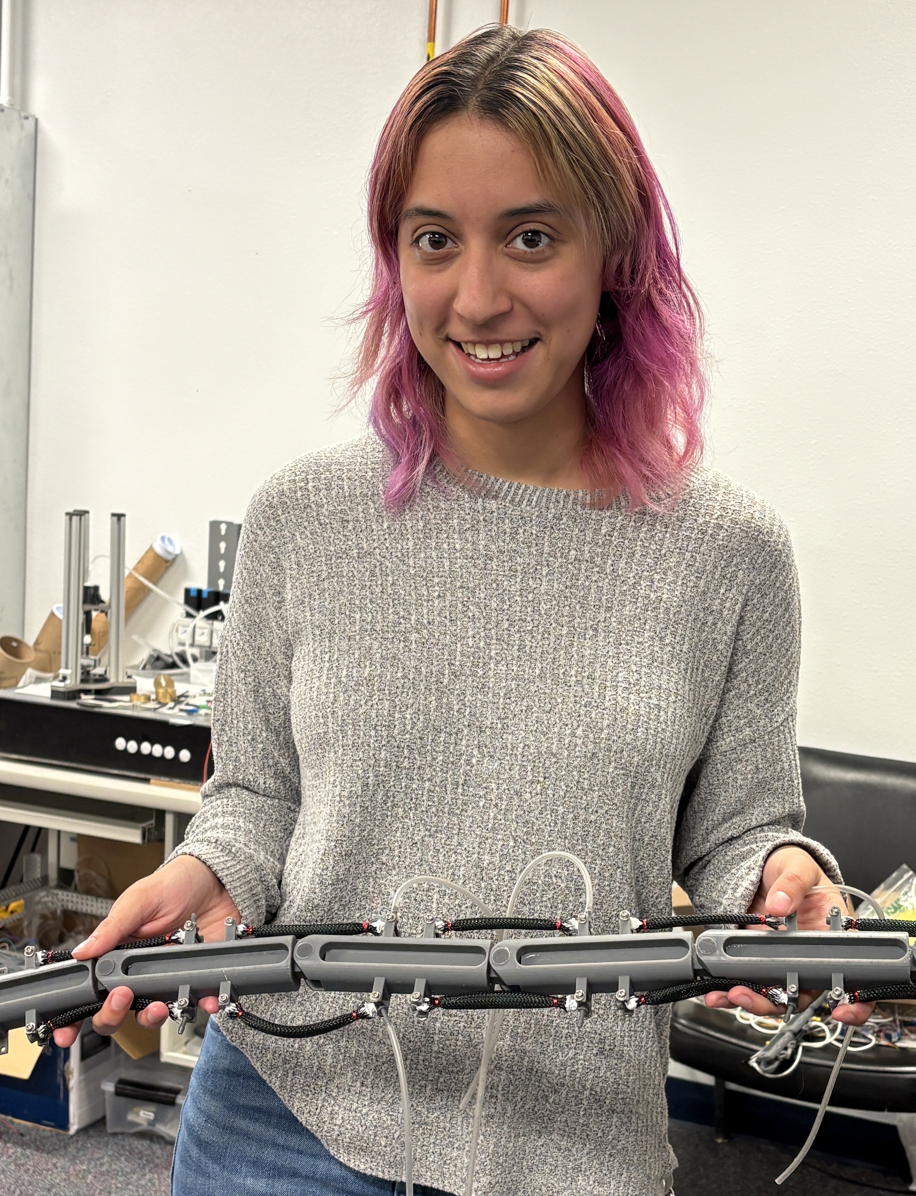 Photo of Sabrina holding a robotic snake