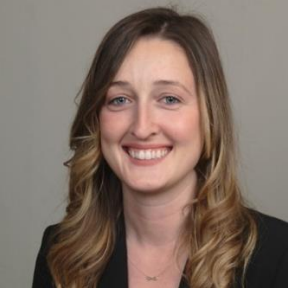 Photo of Randi Potekin, smiling with long hair and black shirt